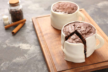 Chocolate cakes in shape of coffee cups on grunge backgroundの写真素材