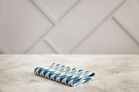 Napkin on table against light background
