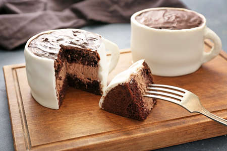 Chocolate cakes in shape of coffee cups on boardの写真素材