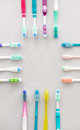 Many tooth brushes on light backgroundの写真素材