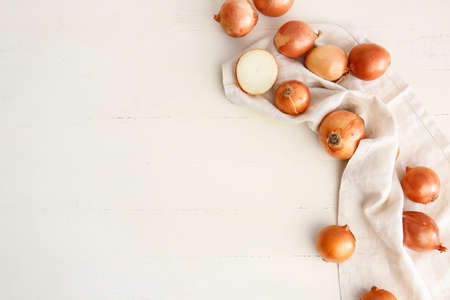 Fresh raw onion on white tableの写真素材