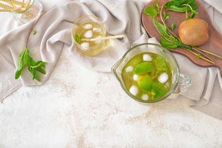 Jug and glass of tasty cold tea on white backgroundの写真素材