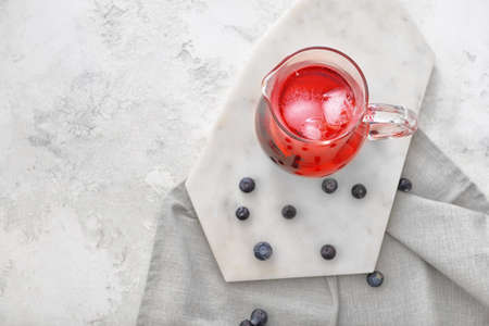 Jug of tasty cold tea on white backgroundの写真素材