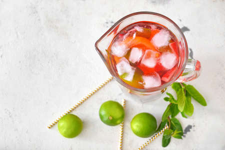 Jug of tasty cold tea on white backgroundの写真素材