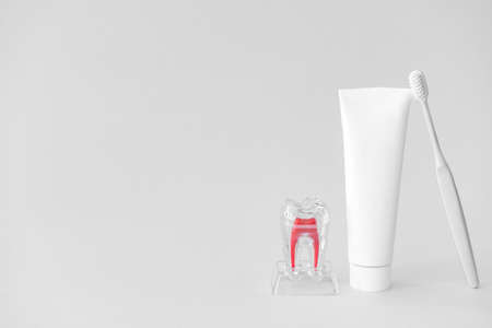 Tooth brush and paste on light backgroundの写真素材