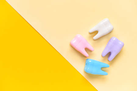 Plastic teeth on color backgroundの写真素材