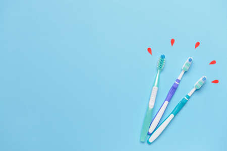 Tooth brushes and drops of blood on color background. Concept of sensitive dentsの写真素材