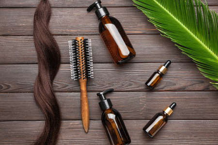 Cosmetics for hair on wooden backgroundの写真素材