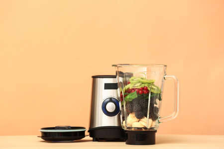 Blender with ingredients for healthy smoothie on color backgroundの写真素材