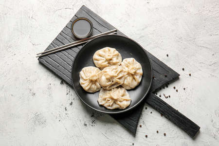 Plate with tasty dumplings on light backgroundの写真素材
