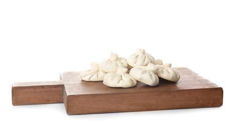 Board with uncooked dumplings on white backgroundの写真素材