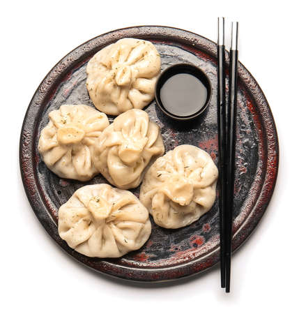 Plate with tasty dumplings on white backgroundの写真素材