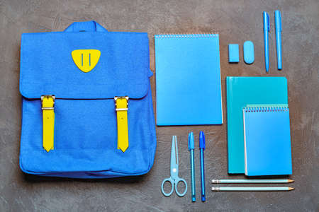 School backpack and stationery on gray backgroundの写真素材