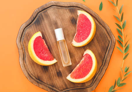 Bottle of citrus roll-on perfume on color backgroundの写真素材