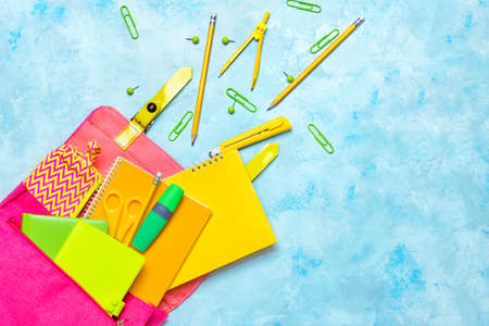 School backpack and stationery on color backgroundの写真素材