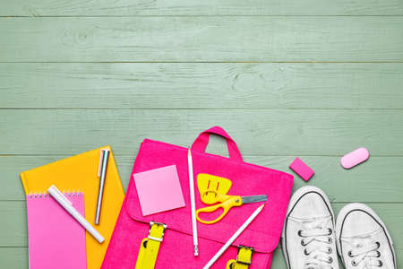 School backpack and stationery on wooden backgroundの写真素材