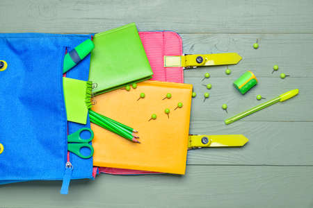 School backpack and stationery on wooden backgroundの写真素材