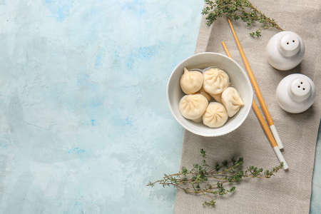 Bowl with tasty dumplings on color backgroundの写真素材