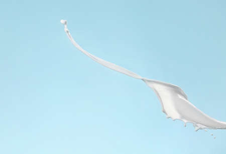 Splash of milk on color backgroundの写真素材