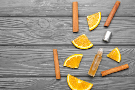 Bottle of roll-on perfume with ingredients on gray wooden backgroundの写真素材