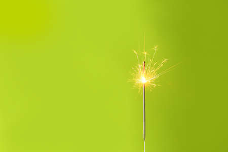 Beautiful Christmas sparkler on color backgroundの写真素材