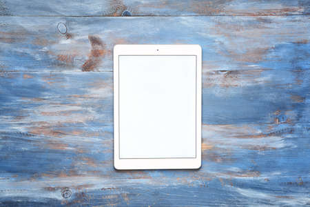 Modern tablet computer on color wooden backgroundの写真素材