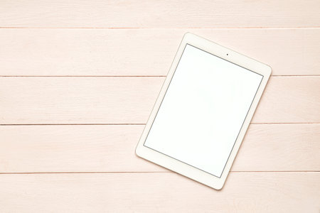 Modern tablet computer on wooden backgroundの写真素材