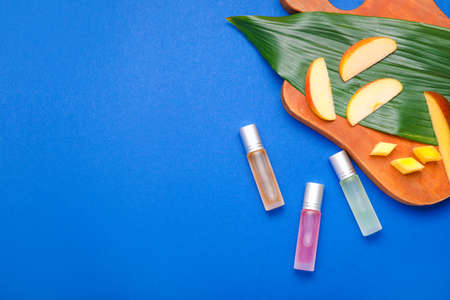 Bottles of tropical roll-on perfume on color backgroundの写真素材