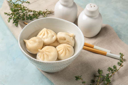 Bowl with tasty dumplings on color backgroundの写真素材