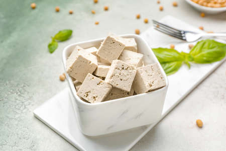 Bowl with tasty tofu cheese on tableの写真素材