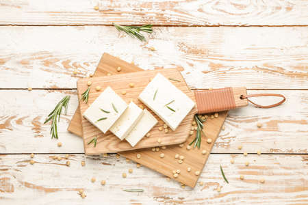 Boards with tasty tofu cheese on table