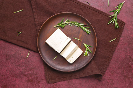 Plate with tasty tofu cheese on color backgroundの写真素材