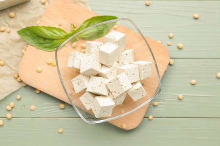 Bowl with tasty tofu cheese on tableの写真素材