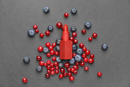 Lipstick and berries on dark backgroundの写真素材