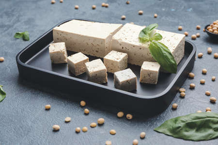 Plate with tasty tofu cheese on dark backgroundの写真素材