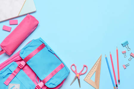 School backpack and stationery on color backgroundの写真素材