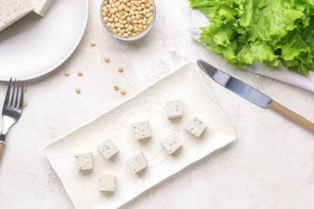 Plate with tasty tofu cheese on white backgroundの写真素材