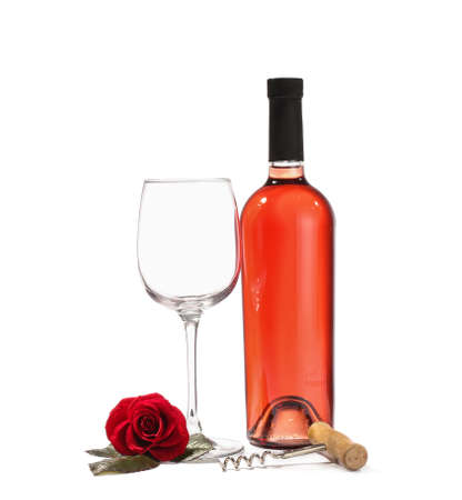 Glass and bottle of wine with rose flower on white backgroundの写真素材