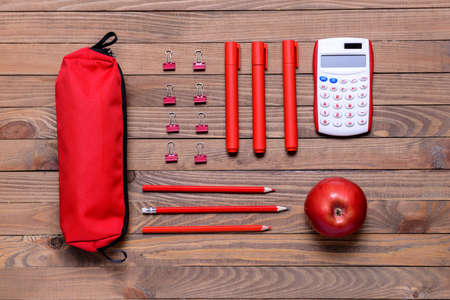 Pencil case and school stationery on wooden backgroundの写真素材