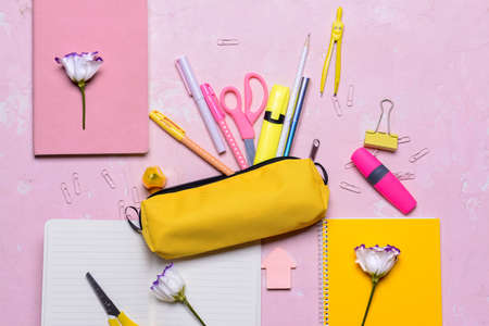 Pencil case and school stationery on color backgroundの写真素材