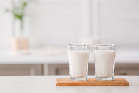 Glasses of fresh milk on tableの写真素材