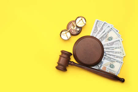 Judge's gavel, scales of justice and money on color backgroundの写真素材