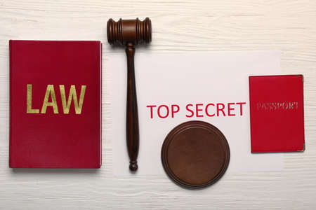 Judge's gavel, book, passport and paper with text TOP SECRET on white wooden backgroundの写真素材