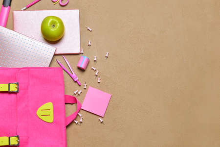 School backpack and stationery on color backgroundの写真素材