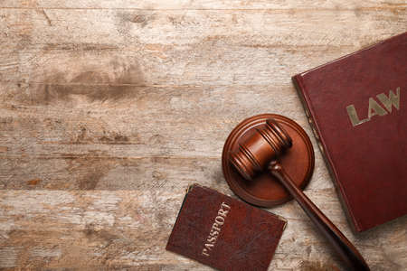 Judge's gavel, book and passport on wooden backgroundの写真素材