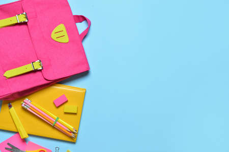 School backpack and stationery on color backgroundの写真素材