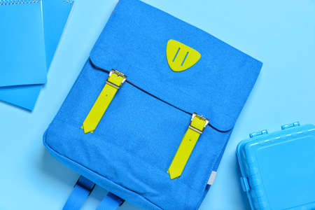 School backpack, lunchbox and notebooks on color backgroundの写真素材