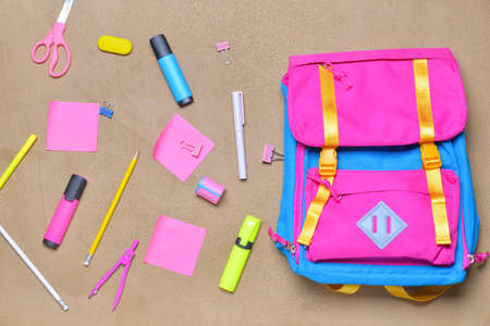 School backpack and stationery on color backgroundの写真素材