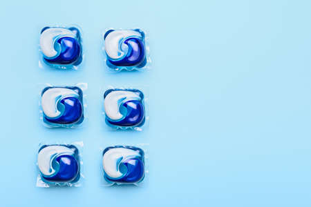 Capsules with laundry detergent on color backgroundの写真素材