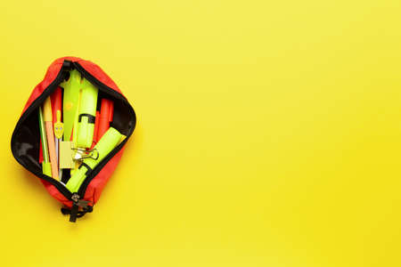 Pencil bag with stationery on color backgroundの写真素材